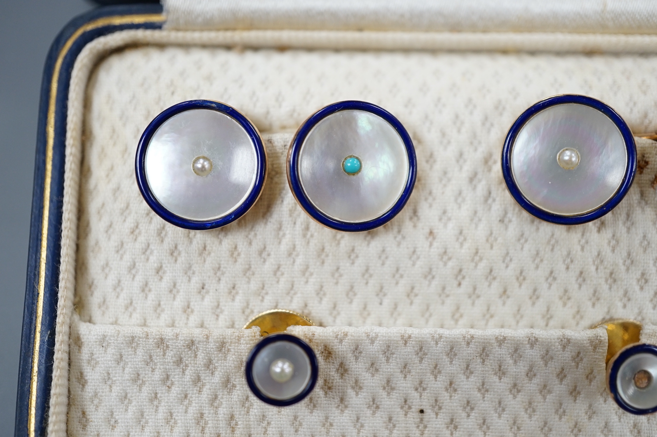 A cased four piece 9ct, mother of pearl turquoise and blue enamel dress stud set, comprising a pair of cufflinks and two studs